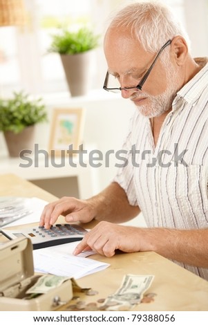 stock-photo-older-man-concentrating-on-financial-job-using-calculator-at-home-79388056.jpg